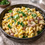 A vibrant bowl of Mexican Street Corn Pasta Salad on a wooden table.